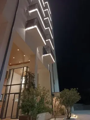 a building with lights on the side of it at M&A apartman in Jagodina
