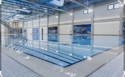 a large swimming pool in a large room at M&A apartman in Jagodina