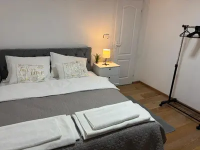 a bedroom with a bed with a lamp and a tripod at Royal Homolje Apartments in Žagubica