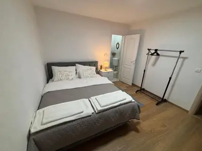 a bedroom with a large bed in a room at Royal Homolje Apartments in Žagubica