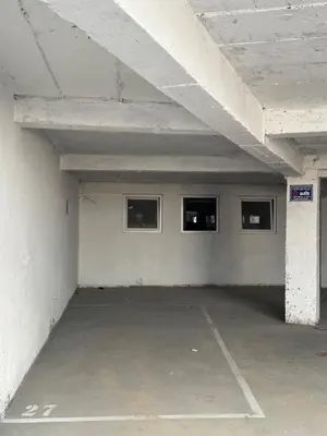 an empty parking garage with three windows in it at Golden Crown 2 in Vranje