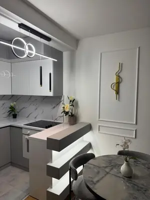 a kitchen with a table and a dining room at Golden Crown 2 in Vranje