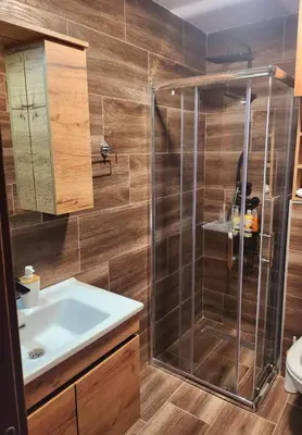 a bathroom with a shower and a sink at Gali lux apartmani in Kopaonik