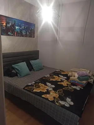 a bedroom with a bed with a blanket on it at Apartman Hedon in Vrnjačka Banja