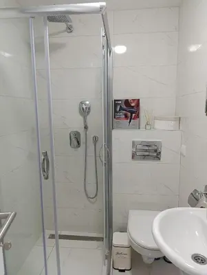a bathroom with a shower and a toilet and a sink at Apartman Hedon in Vrnjačka Banja