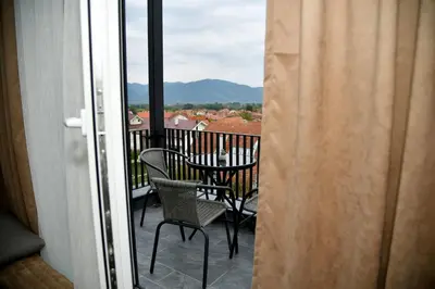 a balcony with chairs and a table with a view at Apartman Dimić, Vrnjačka Banja in Vrnjačka Banja