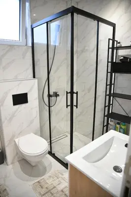 a bathroom with a shower and a toilet and a sink at Apartman Dimić, Vrnjačka Banja in Vrnjačka Banja