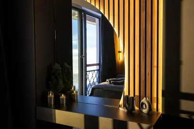 a living room with a table and a window at Luxe Horizon & Spa Apartments Kopaonik in Kopaonik