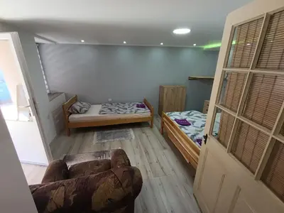 a room with two beds and a couch at Apartman Marina i Sobe Luka in Bukorovac