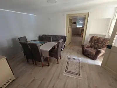 a living room with a dining room table and chairs at Apartman Marina i Sobe Luka in Bukorovac