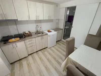 a small kitchen with white cabinets and a sink at Apartman Marina i Sobe Luka in Bukorovac