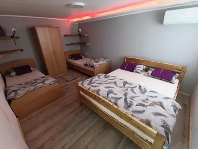 two beds in a room with a room with twoperate at Apartman Marina i Sobe Luka in Bukorovac