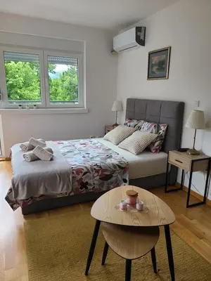a bedroom with a bed and a coffee table at Apartman Živković in Vrnjačka Banja