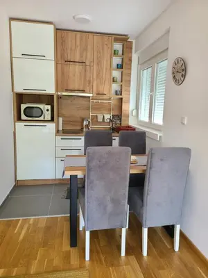 a kitchen with a dining room table and chairs at Apartman Živković in Vrnjačka Banja