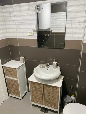 a bathroom with a sink and a mirror at Apartman Živković in Vrnjačka Banja