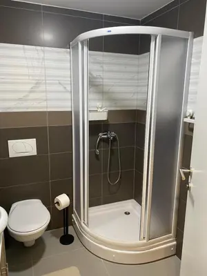 a shower stall in a bathroom with a toilet at Apartman Živković in Vrnjačka Banja