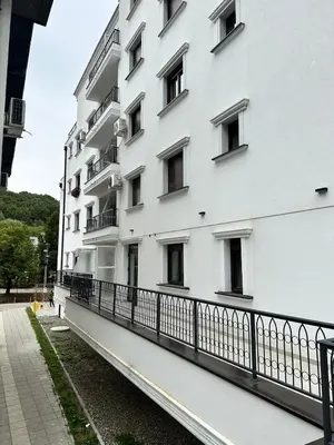 a white building with windows and a balcony at Green Oasis in Vrnjačka Banja