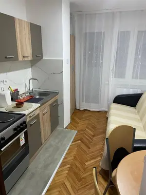 a kitchen with a sink and a stove top oven at Panorama centar, free parking in Niš
