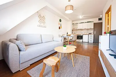 a living room with a couch and a table at Apartments A83 & C32 - Kraljevi Čardaci - Kopaonik in Kopaonik