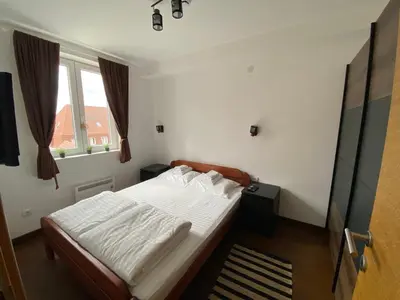a bedroom with a bed with white sheets and a window at Apartments A83 & C32 - Kraljevi Čardaci - Kopaonik in Kopaonik