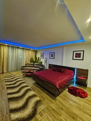a bedroom with a large bed and a couch at Heaven in Niš