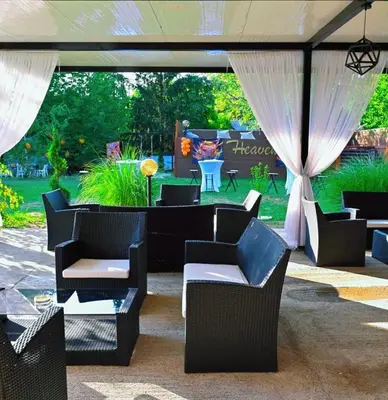 a group of chairs and tables under a tent at Heaven in Niš