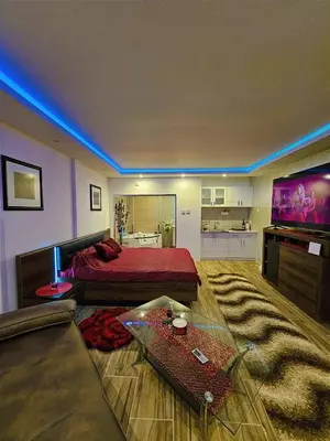a bedroom with a bed and a couch and a tv at Heaven in Niš