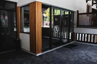 an entrance to a building with glass doors at VujSki - Gondola Apartman in Brzeće