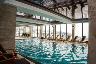 a large swimming pool with chairs in a building at Milmari Bonita Nlux87 in Kopaonik