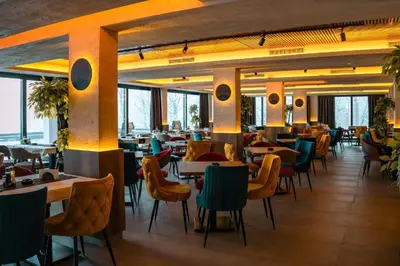 a restaurant with tables and chairs in a room at Milmari Bonita Nlux87 in Kopaonik
