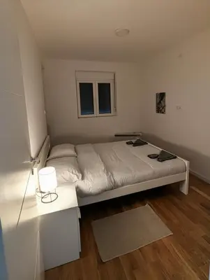 a bedroom with a large bed and a table at Mimi -Green Hill in Soko Banja