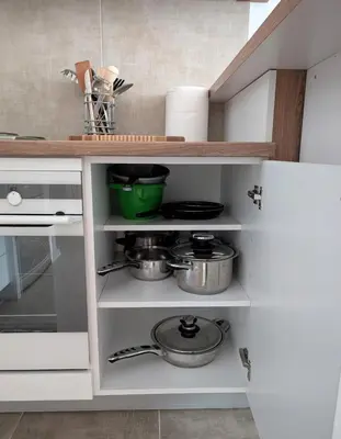 a kitchen with white cabinets with pots and pans at Mimi -Green Hill in Soko Banja