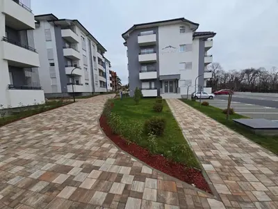 a cobblestone street in front of two apartment buildings at Mimi -Green Hill in Soko Banja