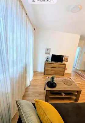 a living room with a couch and a table at Mimi -Green Hill in Soko Banja