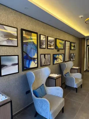a waiting room with two chairs and pictures on the wall at Alpina Lux in Kopaonik