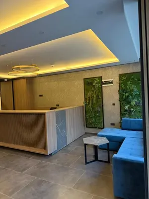 a lobby with blue chairs and a waiting room at Alpina Lux in Kopaonik
