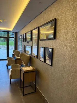 a waiting room with a row of chairs and mirrors at Alpina Lux in Kopaonik