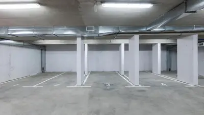 an empty parking lot with white columns and lights at Lawa 22 in Kopaonik