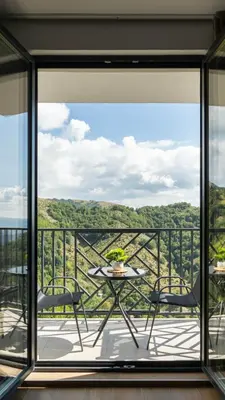 a patio with a table and chairs on a balcony at Lawa 22 in Kopaonik