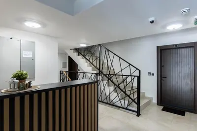 a hallway with a staircase and a black door at Lawa 22 in Kopaonik