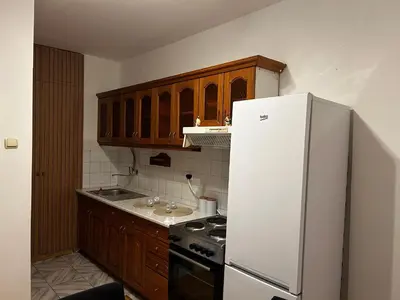 a kitchen with a white refrigerator and a stove at Mance apartments 2 in Paraćin