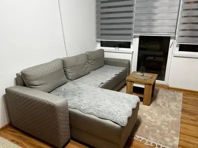 a living room with a couch and a table at Mance apartments 2 in Paraćin