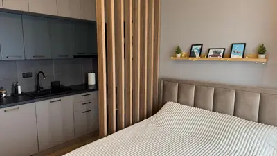 a bedroom with a bed with a large wooden headboard at Pine apartments Residence Hill in Kopaonik