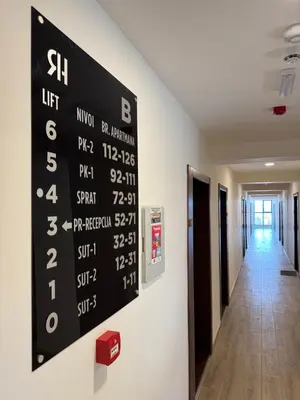 a scoreboard on the wall of a hospital hallway at Pine apartments Residence Hill in Kopaonik
