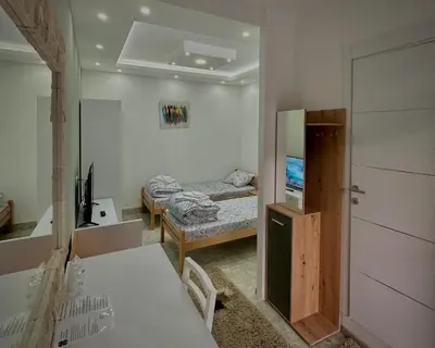 a room with two beds and a mirror in it at Lux A2 in Jošanička Banja