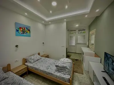 a small room with two beds and a desk at Lux A2 in Jošanička Banja