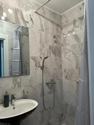 a bathroom with a sink and a shower at Lux A2 in Jošanička Banja