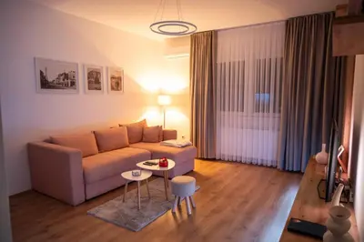 a living room with a couch and a table at 365stay in Vranje