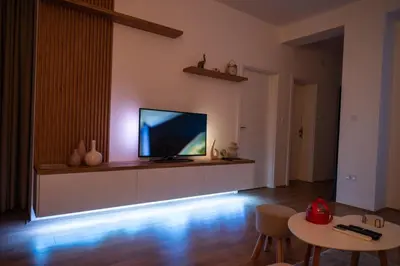 a living room with a flat screen tv on a wall at 365stay in Vranje