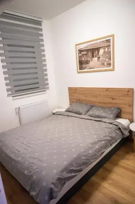 a bedroom with a bed and a window at 365stay in Vranje